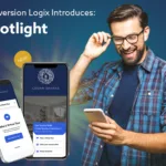 Man wearing glasses looking and smiling at a cell phone he is holding with the cell phone screen display Conversion Logix Spotlight App on a multihousing website