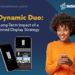 woman wearing an orange sweater holding a cell phone looking at an image of two cell phone with display ads on the screen with an insights icon
